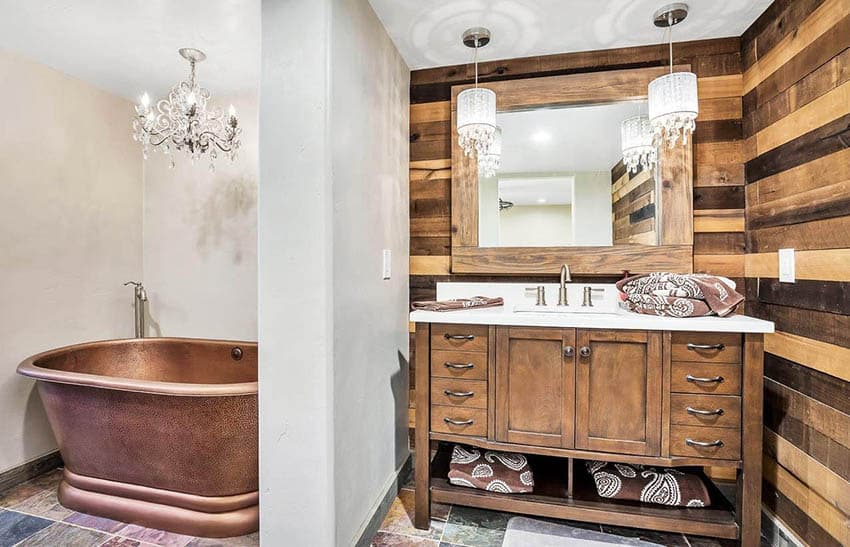 Copper tub in bathroom nook with chandelier