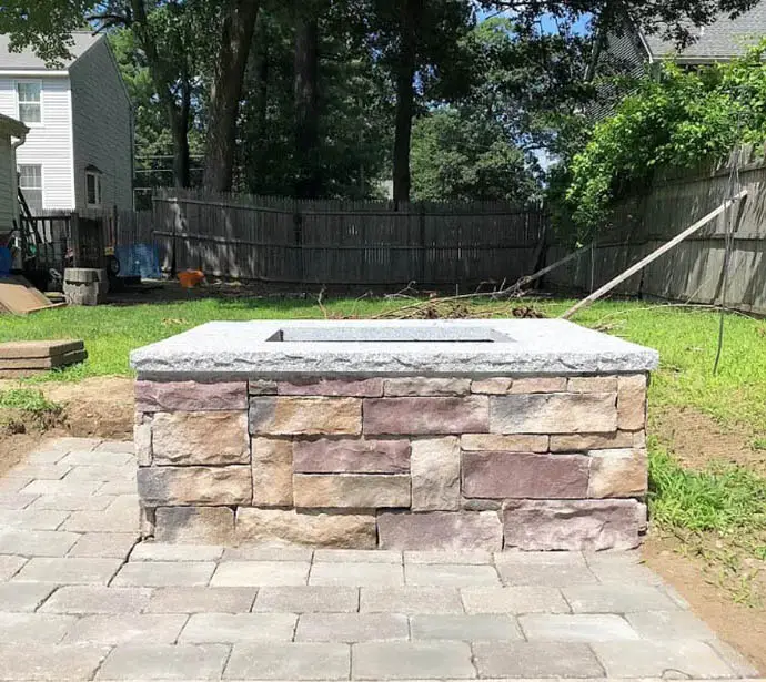 Fire pit with granite top and stone sides