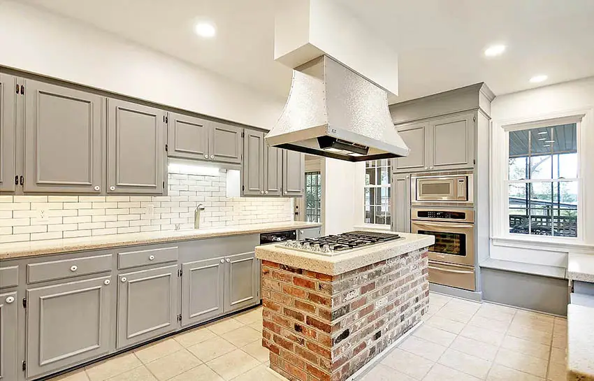 Gray cabinet kitchen with brick island