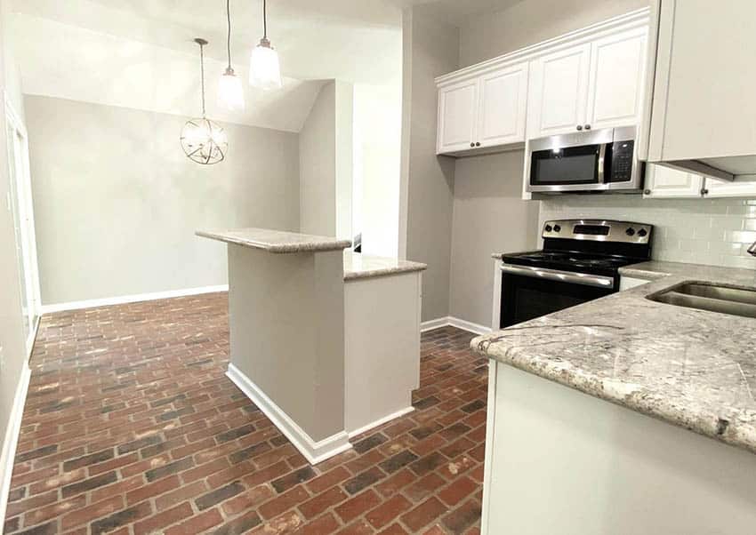 Kitchen with brick floors white cabinets