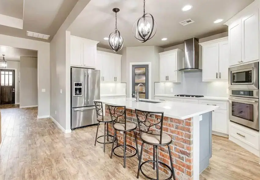 Kitchen with brick island gray paint and white quartz countertop