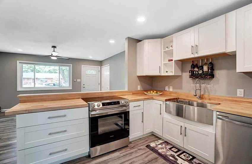 Kitchen with wood butcher block countertops and white painted cabinets