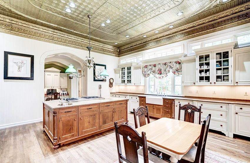 Kitchen with decorative metal ceiling and two tone cabinets