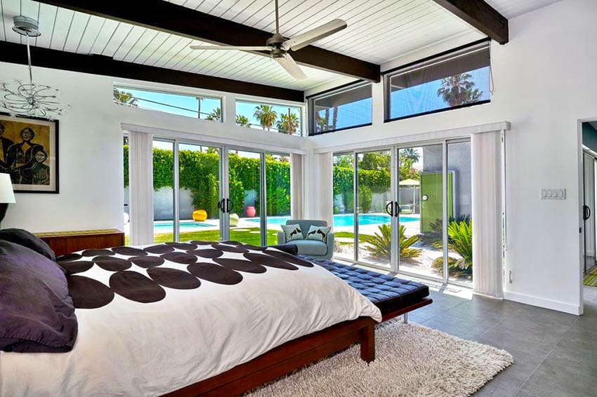 Mid century modern bedroom with pool views open beam ceiling