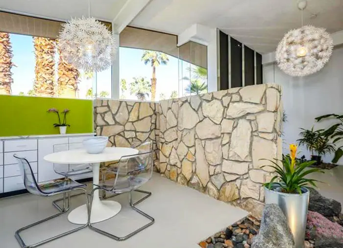 Mid century modern dining area with exposed stone interior
