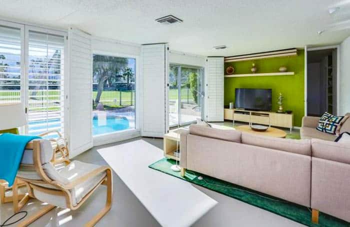 Mid century modern living room with accent wall and large glass sliding doors