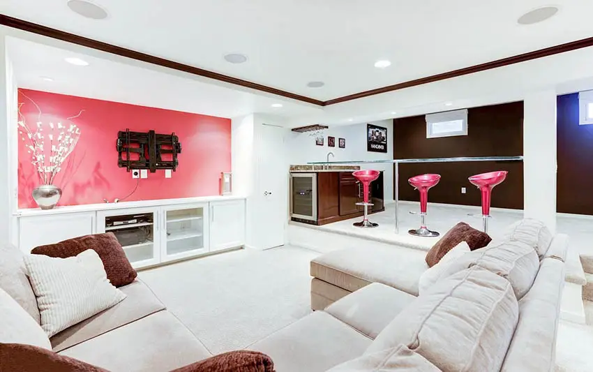 Modern basement with lounge home bar and pink accent wall