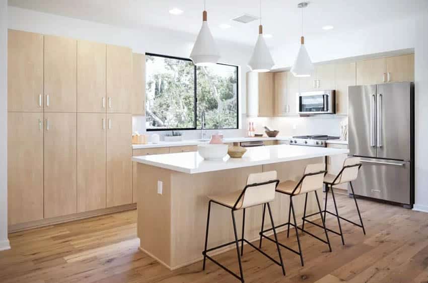 Modern kitchen with white laminate countertops light wood cabinets