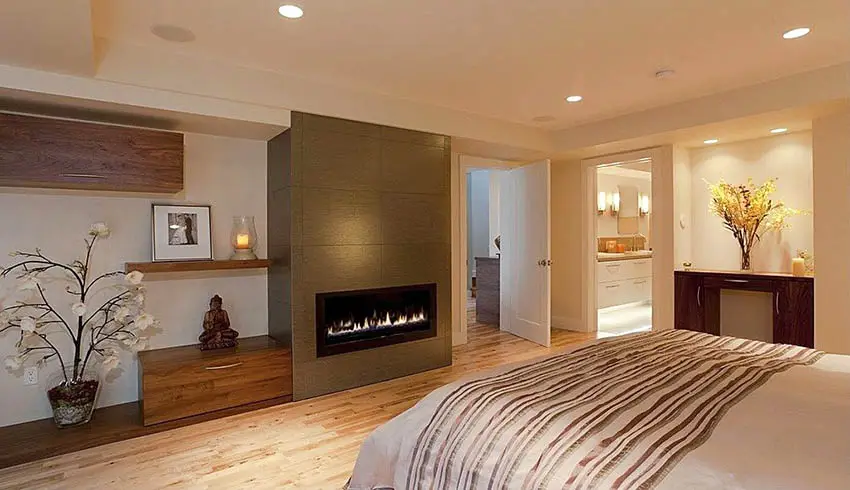Modern master bedroom with gas fireplace and bathroom