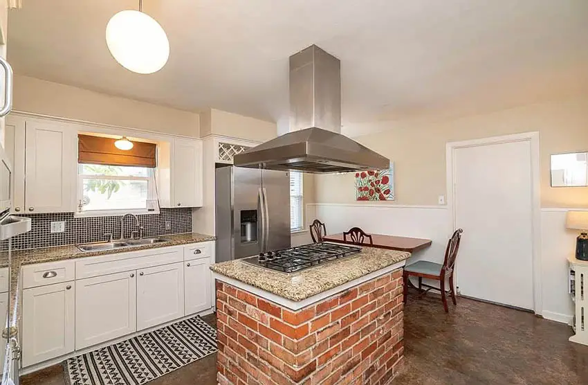 Small kitchen with brick island white cabinets granite countertops