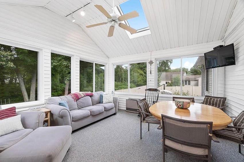 Sunroom with shiplap ceiling and skylight