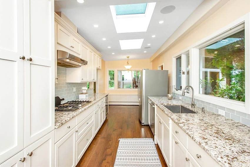 Traditional galley kitchen with skylights white cabinets