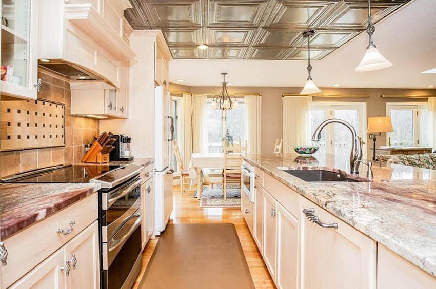 traditional-galley-kitchen-with-tin-ceiling-white-cabinets-wood-flooring