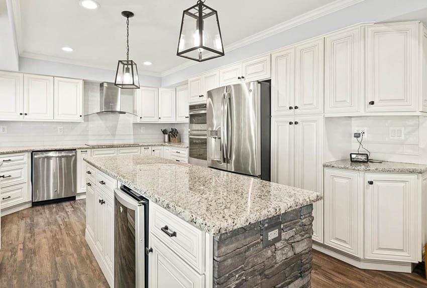 Kitchen with custom stone island with granite countertop and cabinets in antique white finish