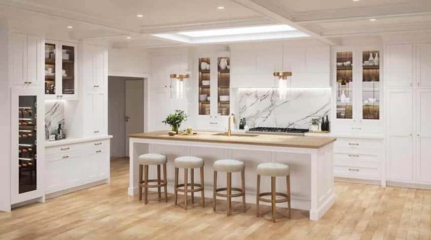 Transitional kitchen with long skylight white shaker cabinets quartz backsplash