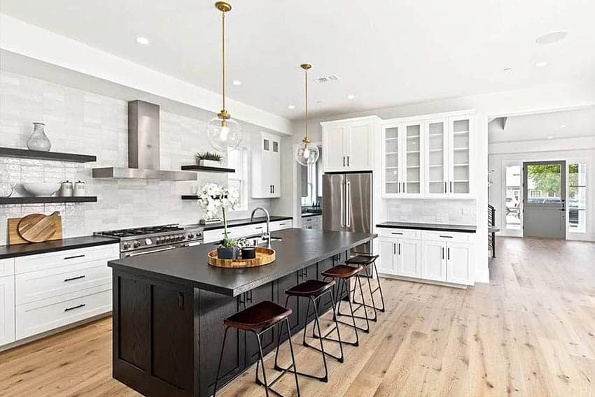 Transitional kitchen with soapstone countertop island white cabinets pendant lights