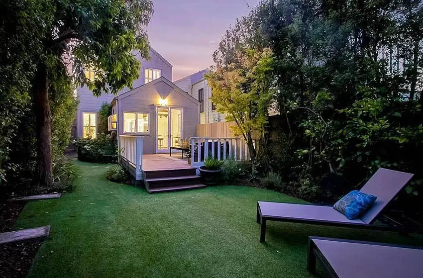 Victorian style house backyard with artificial turf sitting area