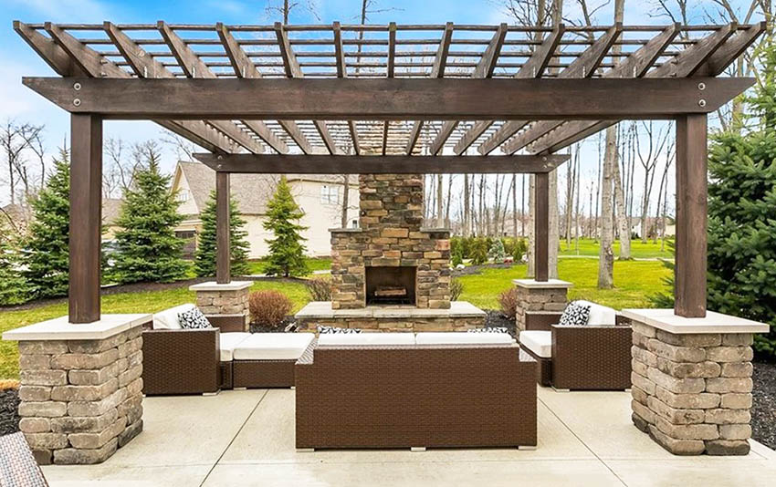 Wood pergola with fireplace and outdoor furniture