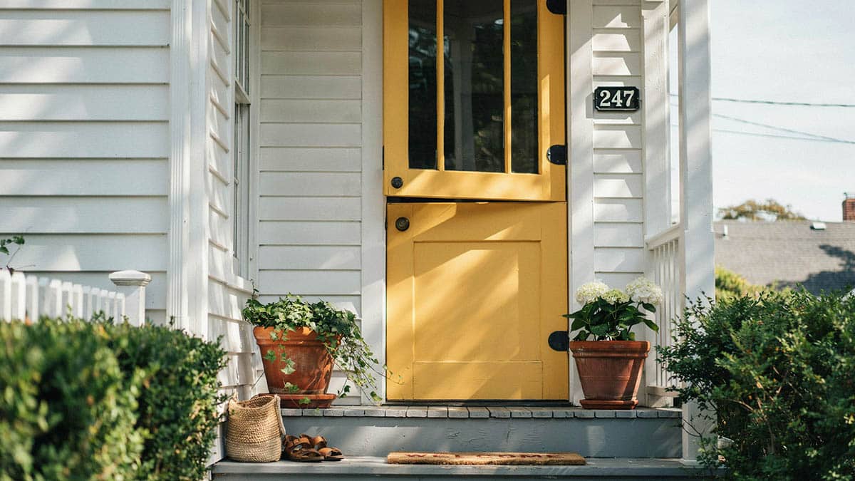 Yellow dutch door with glass panes