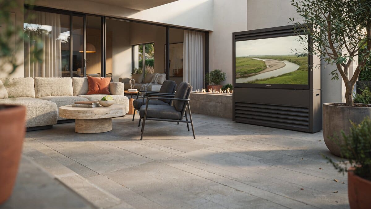 Modern concrete patio with a wide TV enclosure and rattan lounge chairs