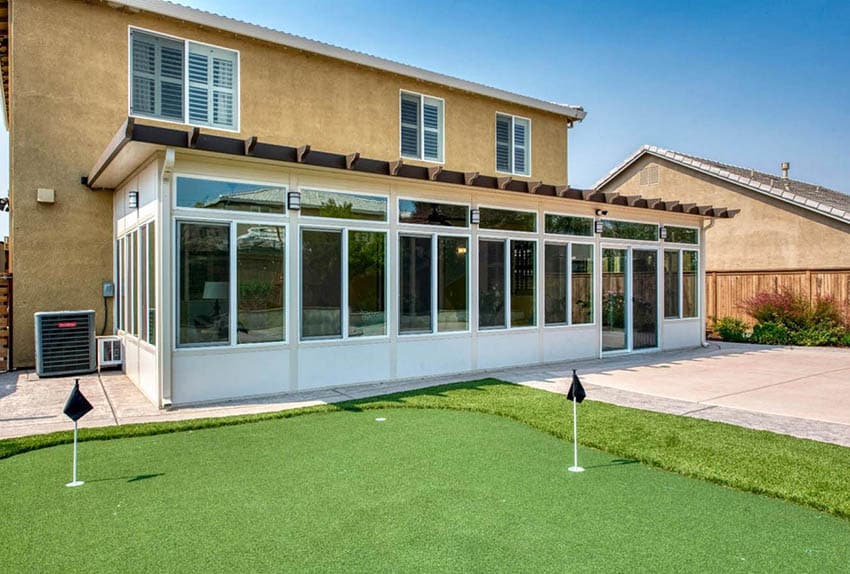 Sunroom attached to house next to putting green