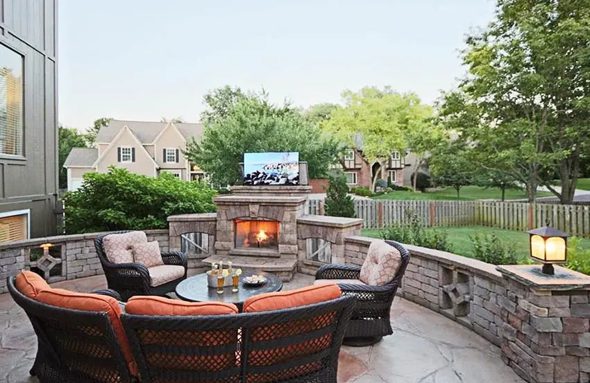 Backyard fireplace with tv mounted above