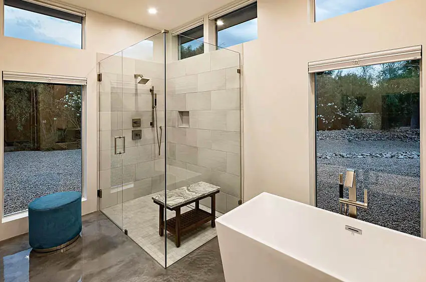 Contemporary bathroom with clerestory windows walk in shower concrete flooring