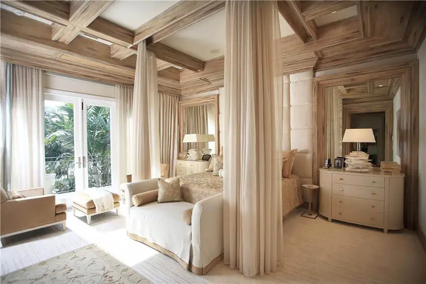 Contemporary bedroom with french doors coffered ceiling and sitting area