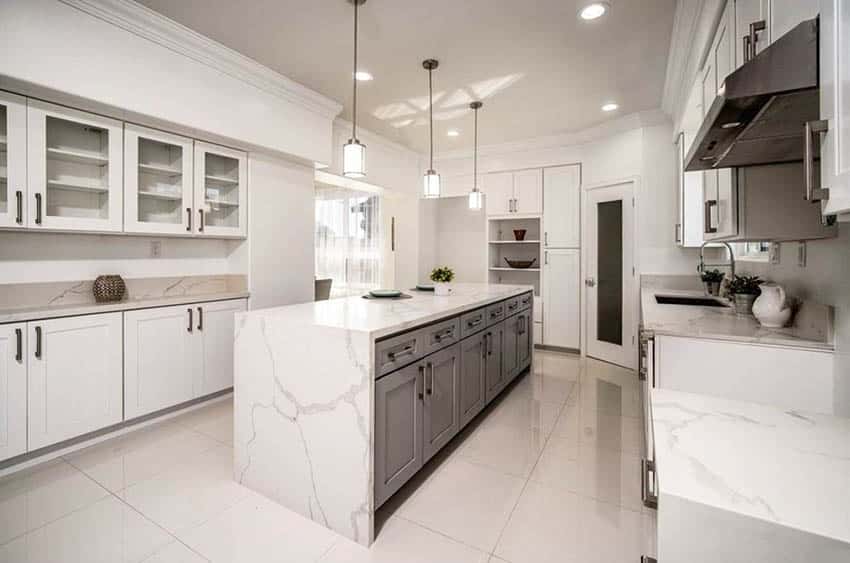 Contemporary kitchen with calacatta gold countertops, white cabinets and pendant lights