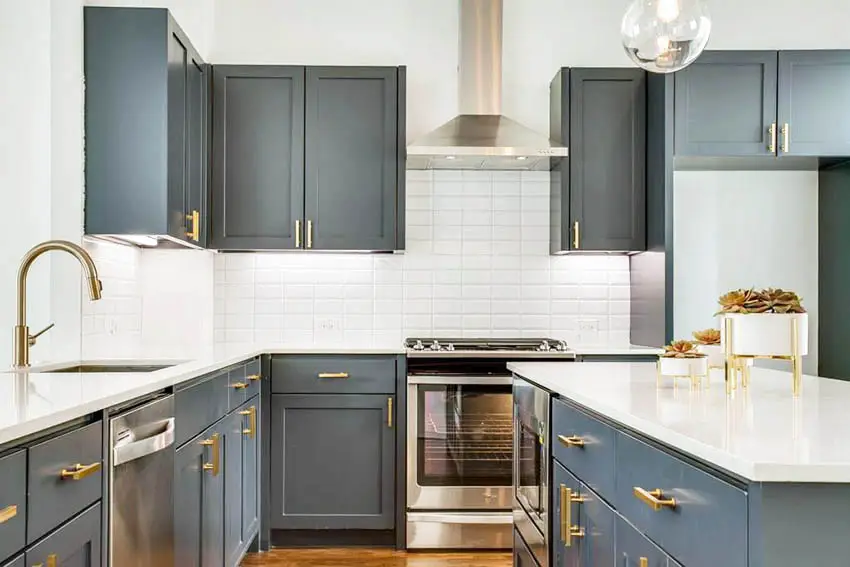 Contemporary kitchen with dark gray cabinets gold cabinet hardware white quartz countertops
