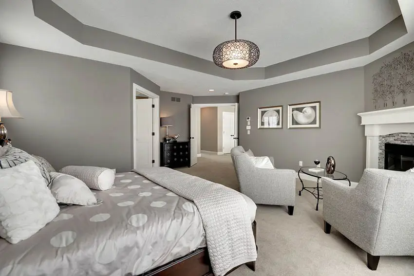 Contemporary master bedroom with fireplace sitting area