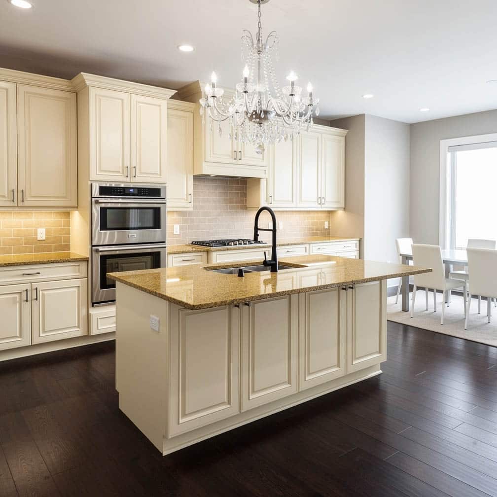 This classic kitchen features cream-colored raised panel cabinets and drawers