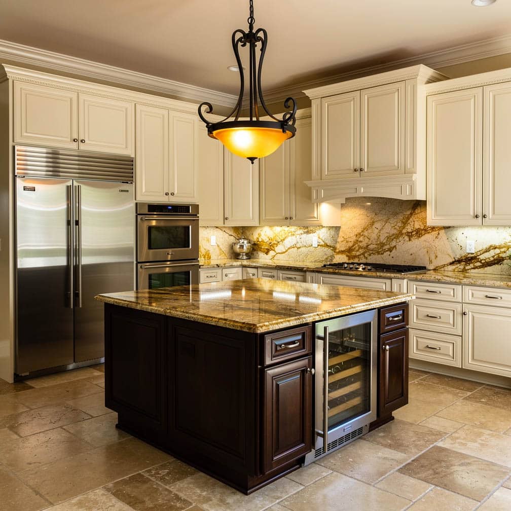 The kitchen island's beige speckled granite countertop is held up