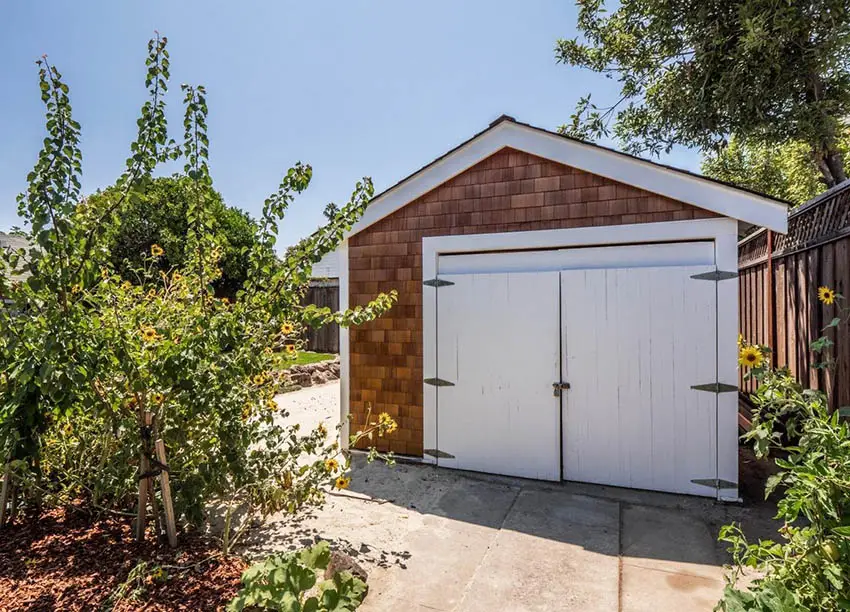 Garage shed with wood shingle siding gate style door