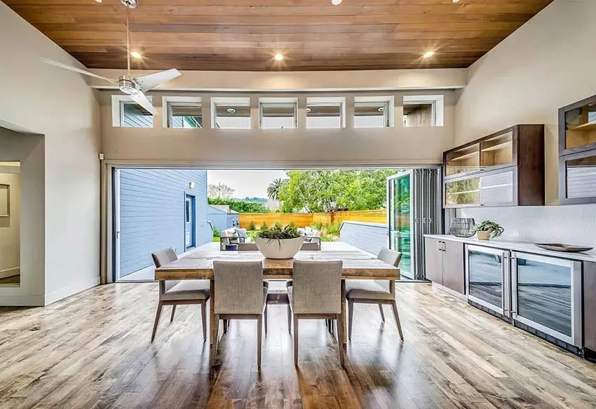 Indoor outdoor living room with clerestory windows wood plank ceiling