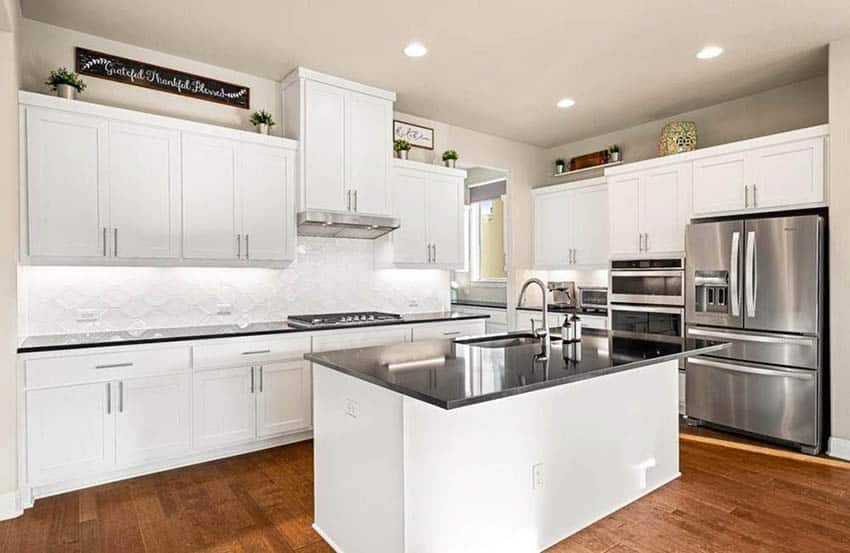 Kitchen with black silestone quartz countertops white cabinets wood flooring