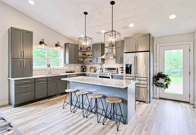 Kitchen with dark gray cabinets and light gray island white granite countertops