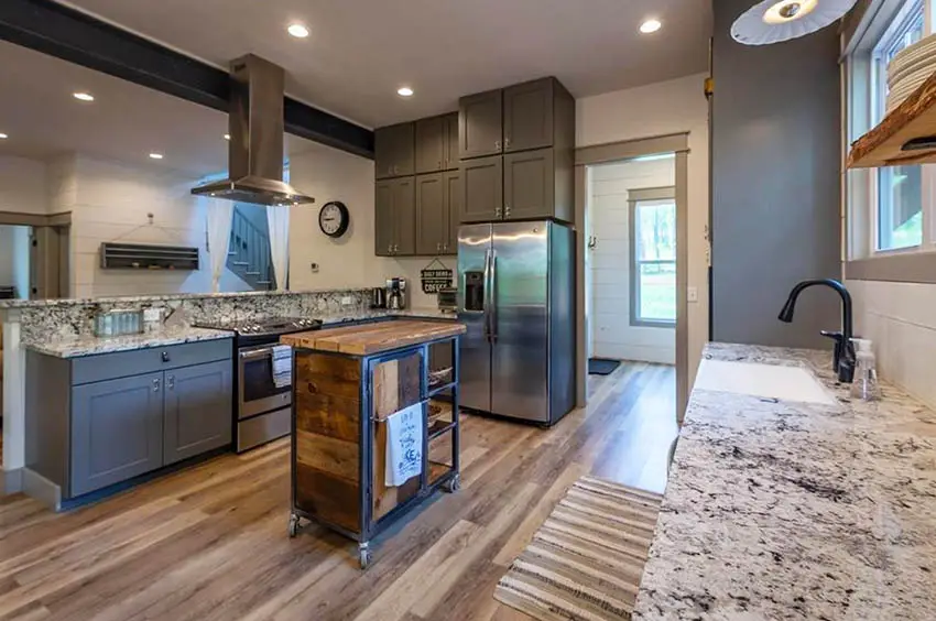 Kitchen with dark gray cabinets breakfast bar peninsula and portable rolling island