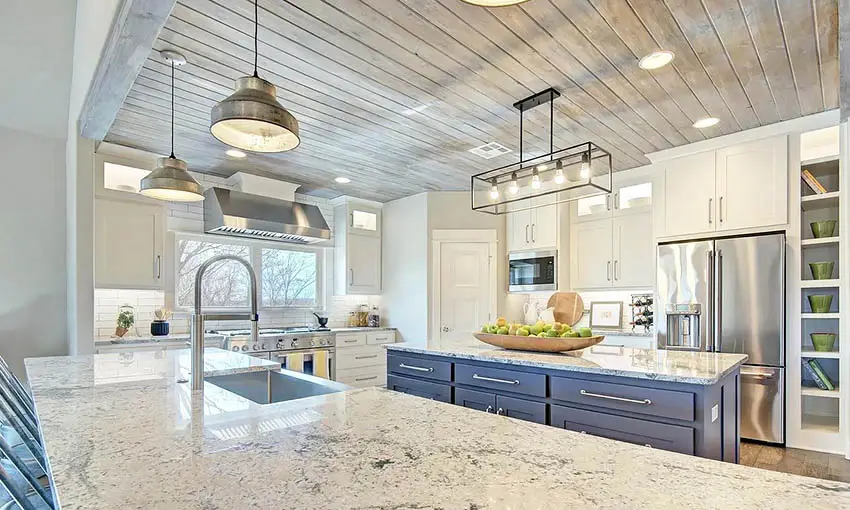 Kitchen with granite peninsula island with blue cabinet and tongue and groove wood ceiling