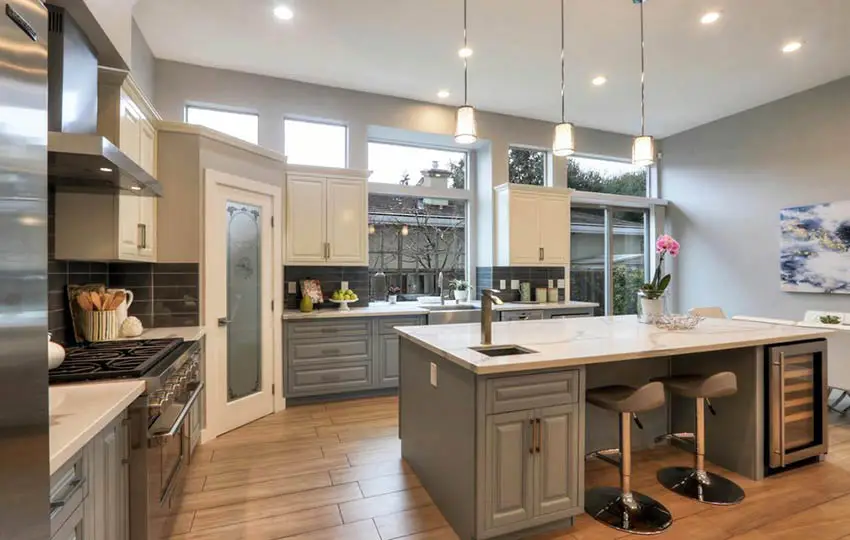 Kitchen with gray cabinets gray wall paint quartz countertops porcelain wood look floors