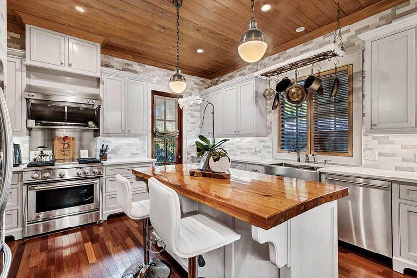 Kitchen with heart of pine reclaimed wood island, white cabinets and Brazilian mahogany flooring