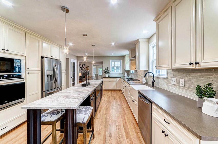 Kitchen with ironbark suede silestone countertops brown fantasy granite island