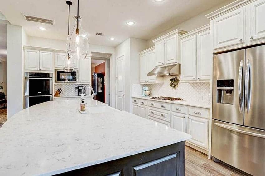 Kitchen with white silestone quartz countertops white cabinets dark wood island