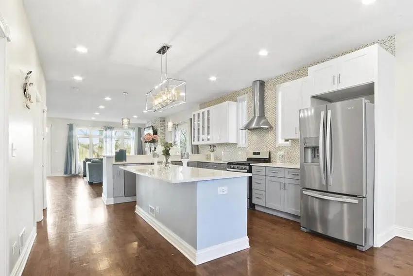 L shaped kitchen with island and peninsula gray and white cabinets