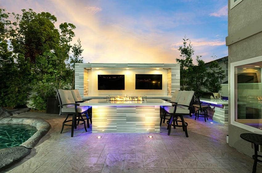 Modern backyard patio with two outdoor tvs in tiled enclosure with gas linear fire pit