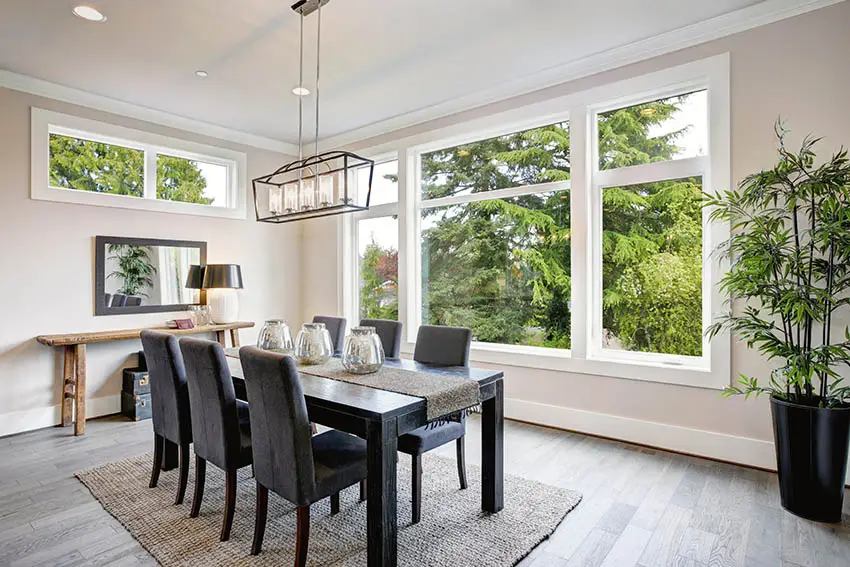 Modern dining room with beige paint color and large windows