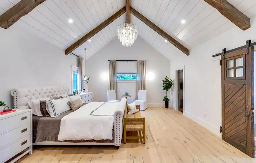 Modern farmhouse bedroom with shiplap cathedral ceiling wood beams flooring