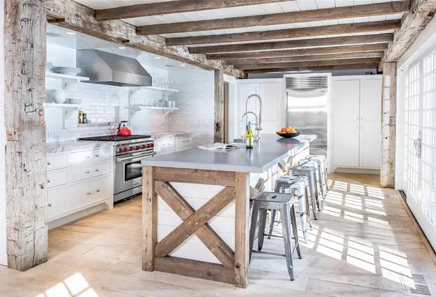 Kitchen with reclaimed beams shiplap island white cabinets wood flooring