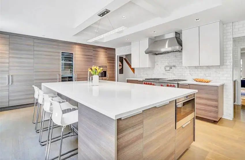 Kitchen with solid surface countertop, engineered wood island and pantry with wooden doors