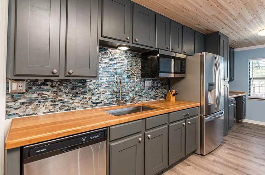 One wall kitchen with countertops and dark gray cabinets